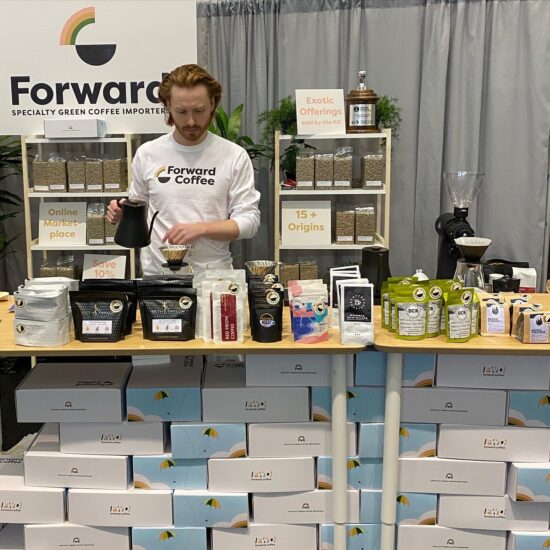 Cole Torode demonstrating coffee brewing at a trade show.