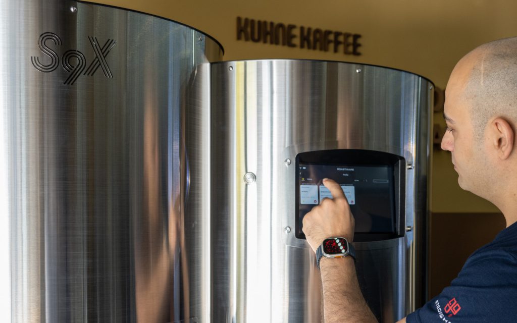 Amir Navid uses the touch screen on a Stronghold S9X electric roaster