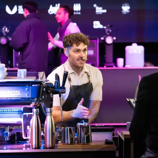 Barista Champion of Australia, Jack Simpson, welcomes judges to his competition routine.