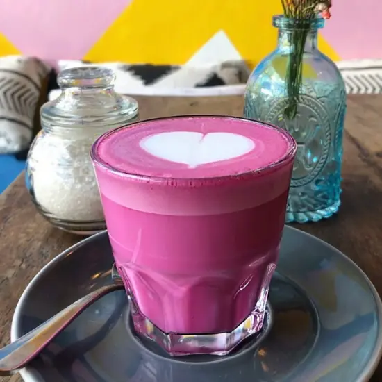 A beetroot latte on a sauce, with a heart on top.