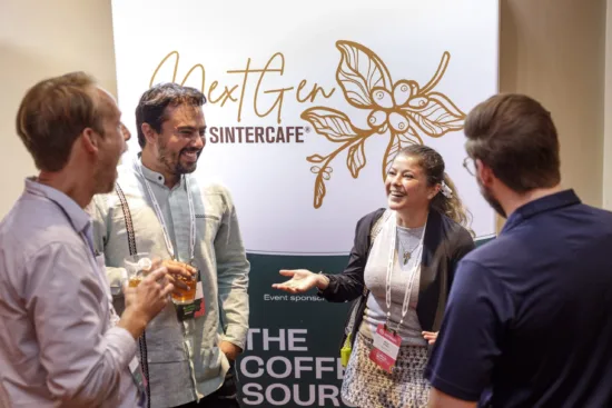 Four people talk at an open house event.