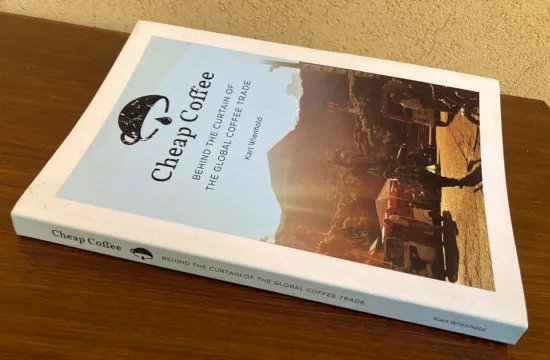 The cover and spine of the Cheap Coffee book, which depict a coffee cup help upside down with a drip of coffee dripping out of it.