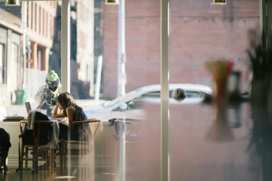 Customers inside a coffee shop window.