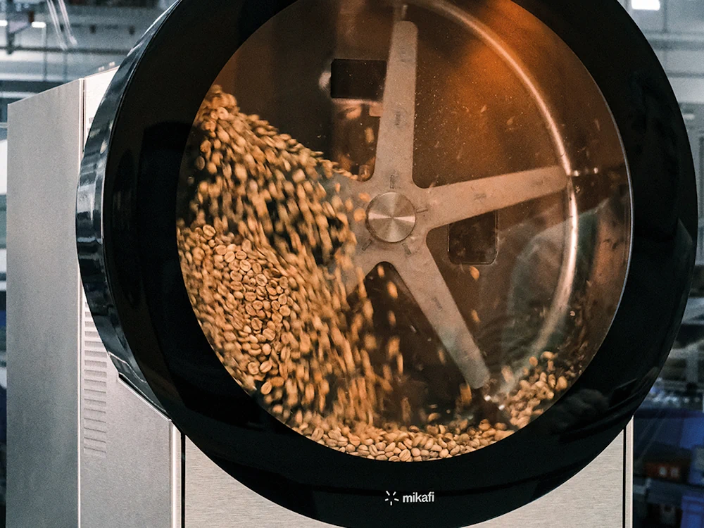 Green coffee being roasted in a Mikafi machine.
